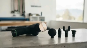 Professional percussion massager with interchangeable attachments.