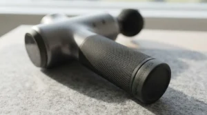 Close-up of the anti-slip ergonomic handle on a premium heat and cold massage gun designed for ease of use.