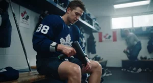 Hockey player using an affordable massage gun for muscle relief in Canada.