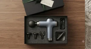 A flat lay layout of a luxury percussion massager for gifting alongside interchangeable massage attachments.